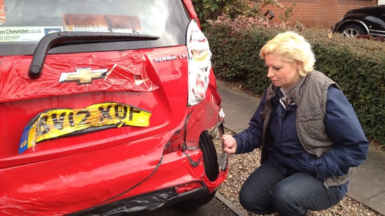Resident asses damage to car 