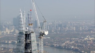 Cranes work on the building.