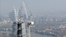 Cranes work on the building.