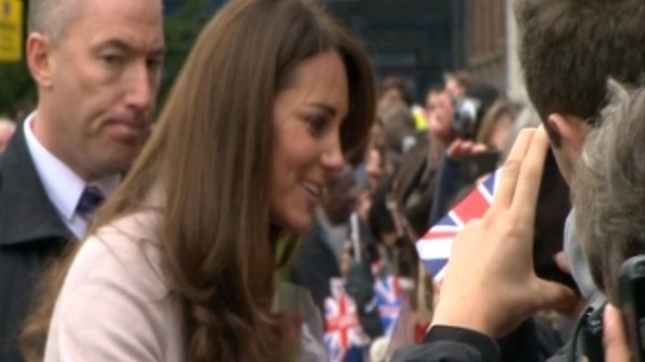 The people of Cambridge hold their British flags.