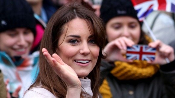 The Duchess of Cambridge waves during a walkabout in the centre of Cambridge.
