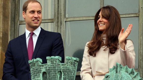 The Duke and Duchess of Cambridge wave to the crowds.