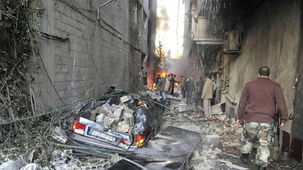 Crowd gathers at the site of a blast in Jaramana district, near Damascus