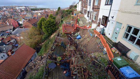 A row of seven cottages high above Whitby harbour are collapsing down the cliff following torrential rainfalls in the region.