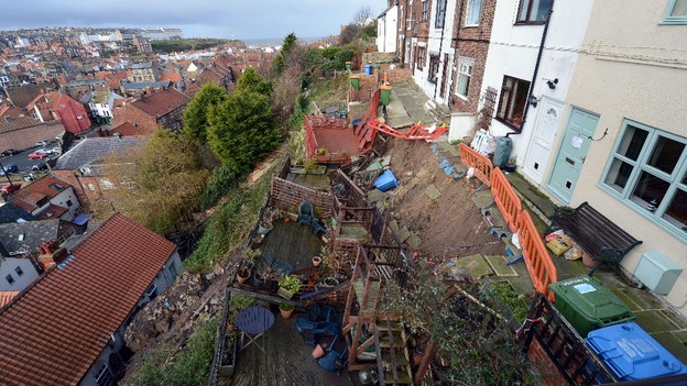 A row of seven cottages high above Whitby harbour are collapsing down the cliff following torrential rainfalls in the region.