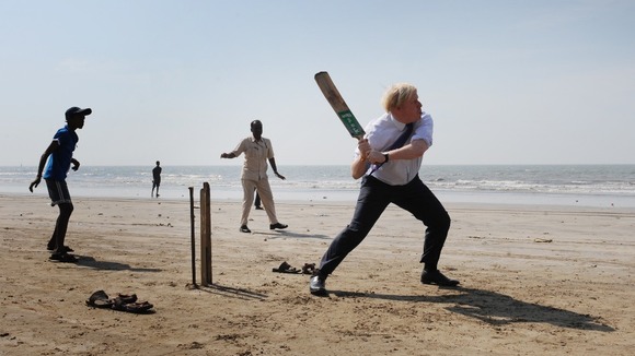 Fielders watch on as Johnson clips a shot in the air.