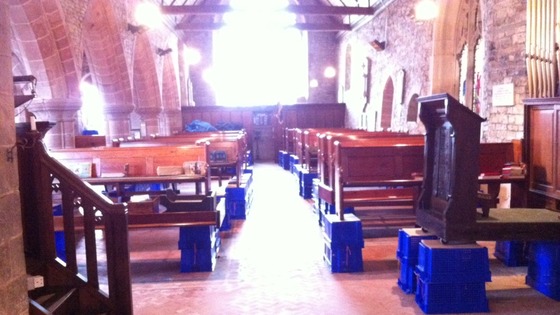 Pews propped up on boxes after flooding affected St Denys Church in Kempsey