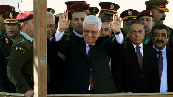 Palestinian President Mahmoud Abbas waves to the cheering crowds in Ramallah