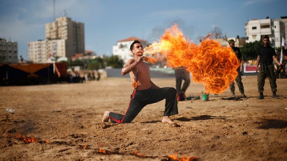 Member of Hamas' national security forces demonstrates his skills at the site of a destroyed security compound in Gaza.