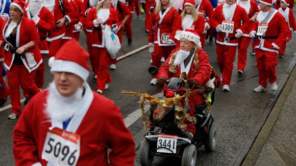Runners dressed in Santa Claus outfits compete in the annual Santa Dash in Liverpool.