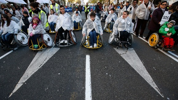 People in wheelchairs take part in a rally against government cutbacks for disabled people in Madrid.