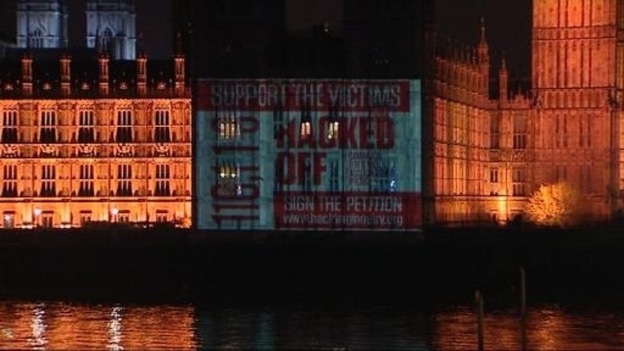 Hacked Off image is projected on to the Houses of Parliament