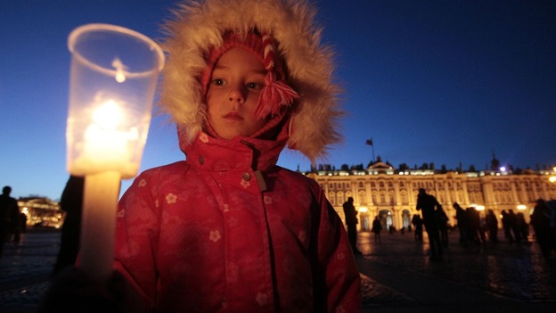 A child lights a candle in St Petersburg
