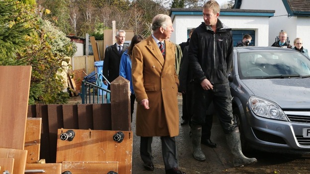 The Prince of Wales walks with flooded home owner Martin Jones
