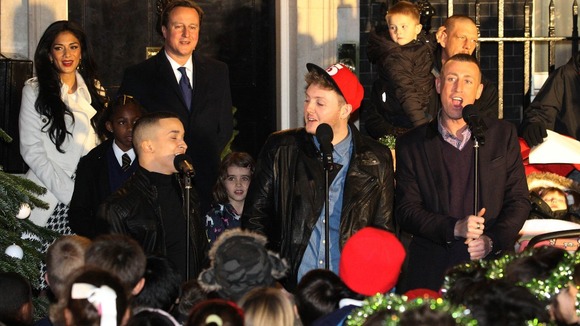 David Cameron watches the X Factor finalists singing outside Number 10