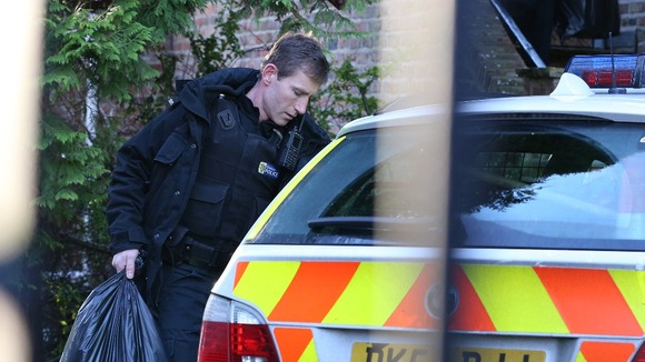 Police carry plastic bags