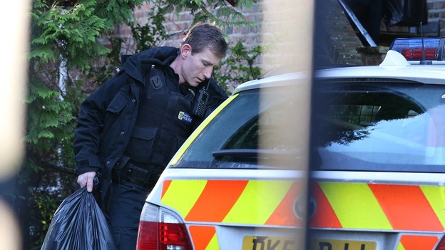 Police carry plastic bags