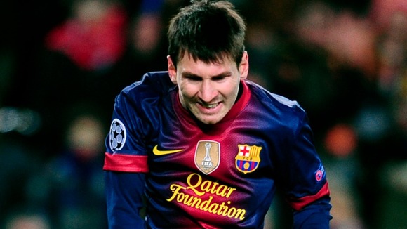 Barcelona's Lionel Messi reacts after suffering an injury during the Group G game against Benfica