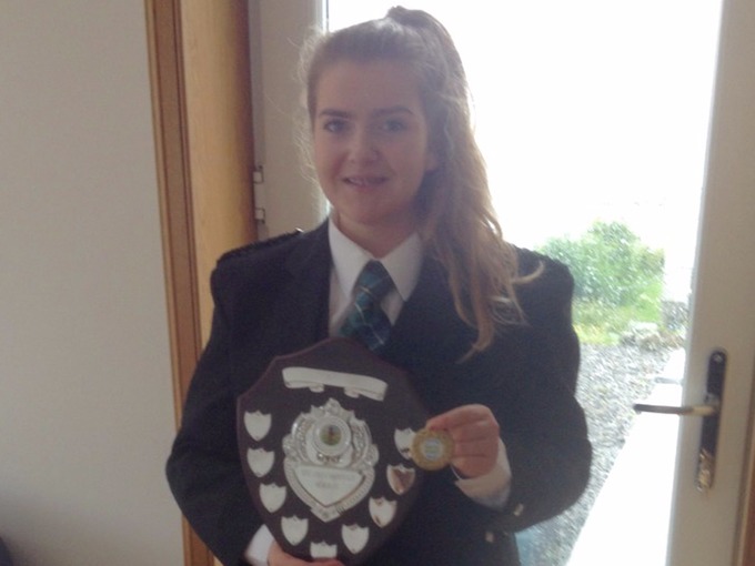 Eilidh MacLeod displays her bagpiping award