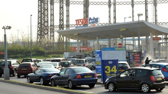 Cars queue for fuel at a Tesco store in Ashford, Middlesex