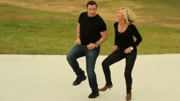 John Travolta and Olivia Newton-John sing their way to Christmas