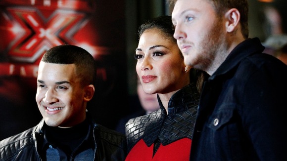 X Factor judge Nicole Scherzinger with finalists James Arthur, right, and Jahmene Douglas during a photocall at Manchester Central.
