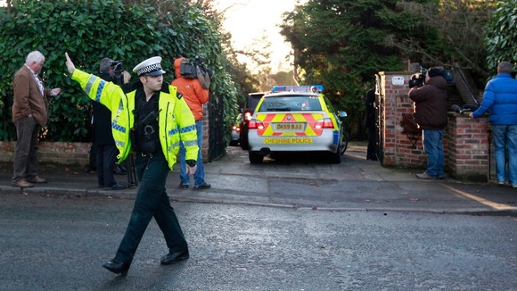 Police and the media outside Stuart Hall's home in Wilmslow, Cheshire.