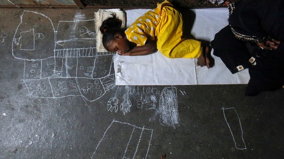 5-year-old Noor Jahan sleeps in a train station in Mumbai