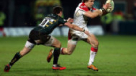 Ulster's Andrew Trimble is tackled by Northampton's Ryan Lamb during the Heineken Cup Pool Four match at Franklins Gardens, Northampton.