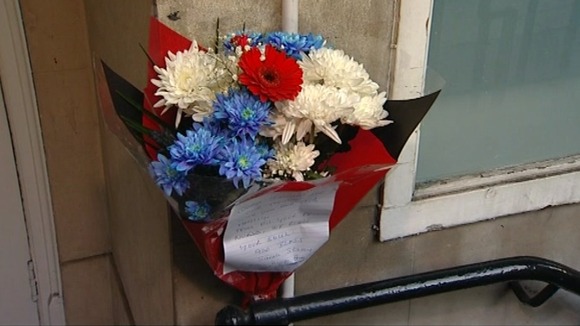 Flowers have been left outside the hospital's nurses' block