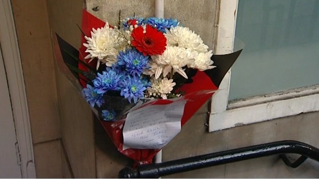 Flowers have been left outside the hospital's nurses' block