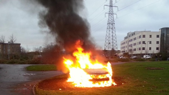 A car on fire in East Belfast during the flag protests.