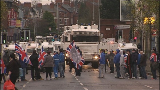 Protesters waving Union flags are faced with a heavy police presence in Belfast.