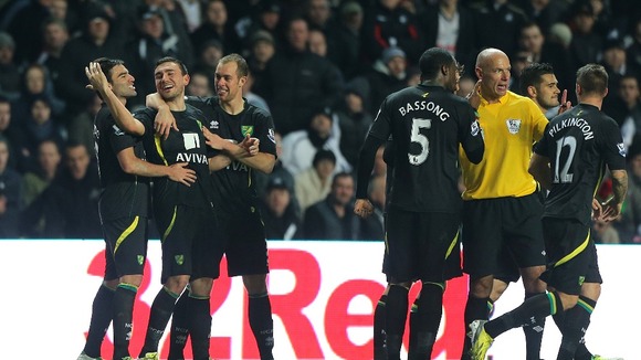 Sebastien Bassong complains to the referee