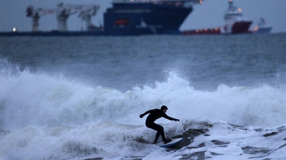 A surfer braves the waters of the North Sea , near Aberdeen