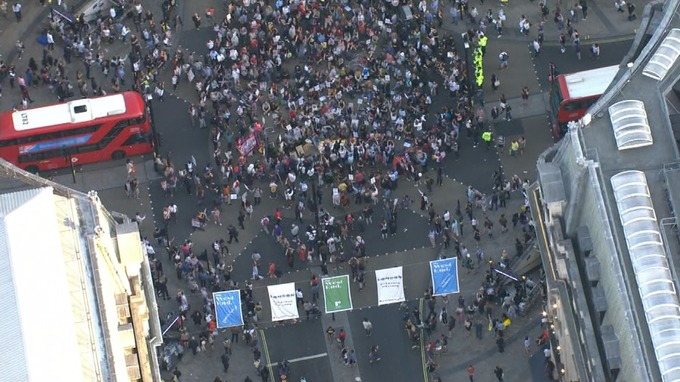 Demonstrators block the road with a sit-in protest