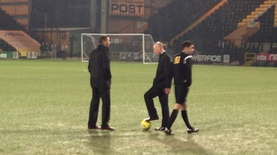 Officials inspect the pitch 