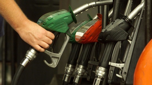 A man uses petrol pumps