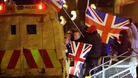 Loyalist protestors carrying Union flags clash with police outside the City Hall in Belfast