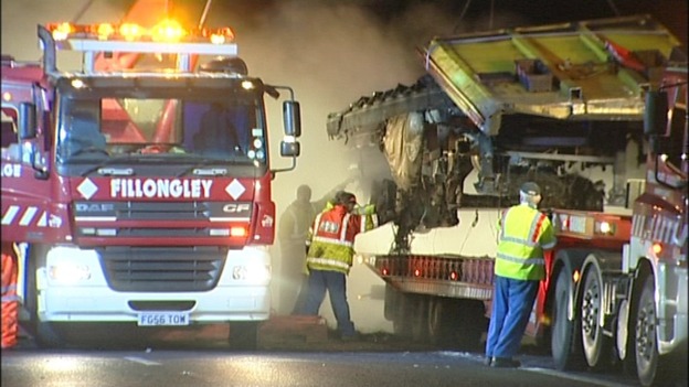 Loading the burnt lorry onto a low loader 