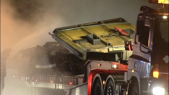 What is left of the chemical lorry being taken away 