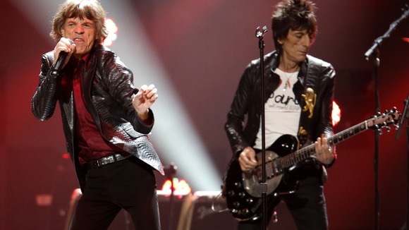 Mick Jagger and Ron Wood of the Rolling Stones perform during the "12-12-12" benefit concert