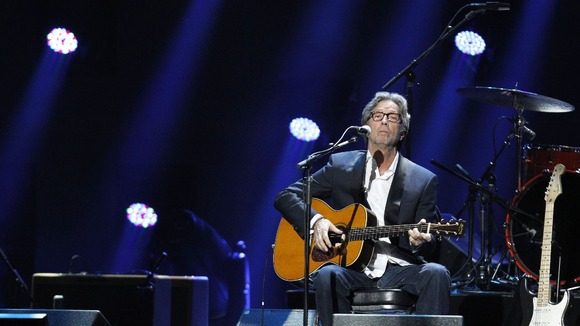 Eric Clapton performs during the "12-12-12" benefit concert