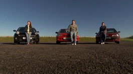3 young people stood next to their car on a racetrack
