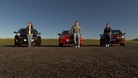 3 young people stood next to their car on a racetrack