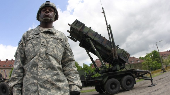A US soldier stands next to a Patriot surface-to-air missile battery at an army base in Morag, Poland.