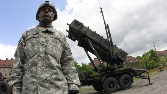 A US soldier stands next to a Patriot surface-to-air missile battery at an army base in Morag, Poland.