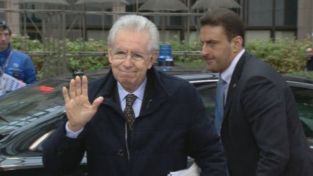 Italian Prime Minister Mario Monti waves as he arrives at the venue in Brussels