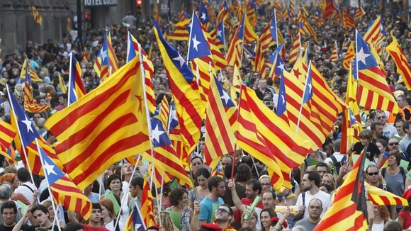 Marchers wave Catalonian nationalist flags as they demonstrate on Catalan National Day, in Barcelona this year.