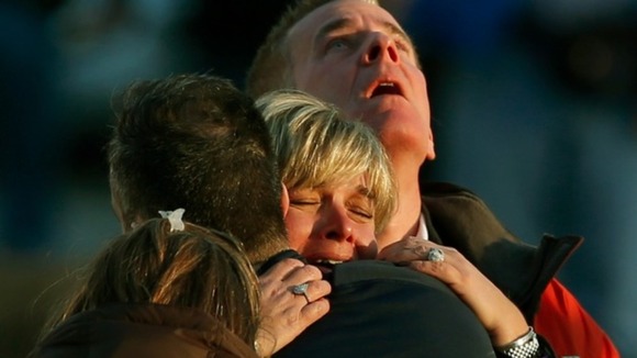 Families have been assembling in a building near the school, as they wait for news